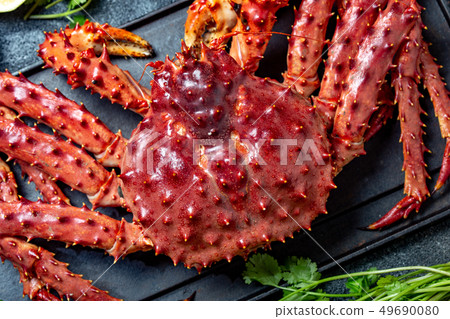 Red king crab on gray background. King crab, lemon and cilantro, top view 49690080