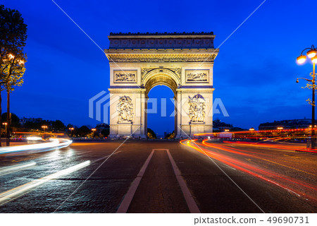 Paris street at night with the Arc de Triomphe in 49690731