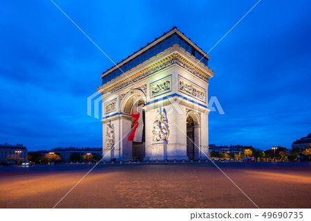 Paris street at night with the Arc de Triomphe in 49690735