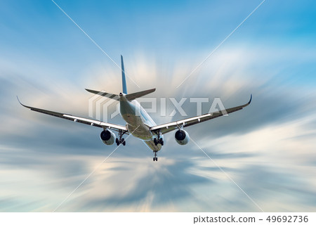 An Airplane is Flying in The Clouds Sky An Airplane is Flying in The Clouds Sky 49692736