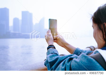 Cityscape on smartphone. View through phone screen 49697790