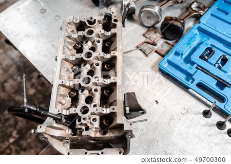 the mechanic opened the locking valve mechanism. Disassemble engine block vehicle. Motor capital the mechanic opened the locking valve mechanism. Disassemble engine block vehicle. Motor capital 49700300