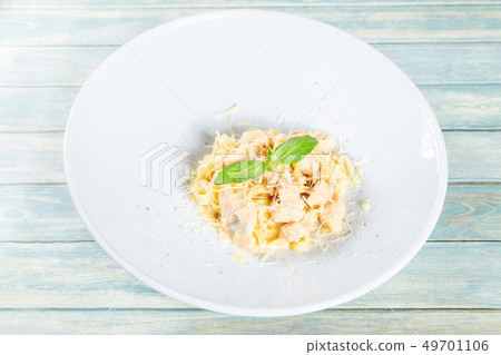 Plate of pasta fetuccini with salmon and parmesan 49701106