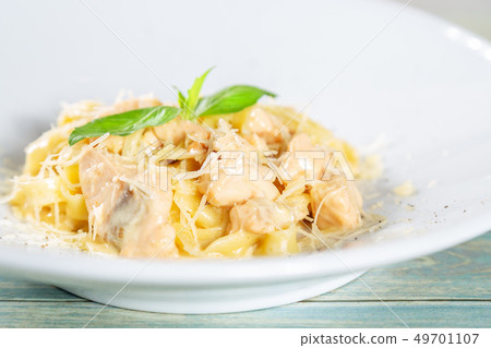 Plate of pasta fetuccini with salmon and parmesan 49701107