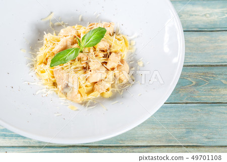 Plate of pasta fetuccini with salmon and parmesan 49701108