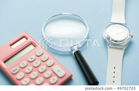 calculator, desktop calculator, magnifying glass 49702783