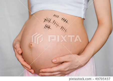 pregnant girl hugs her stomach with a term of pregnancy pregnant girl hugs her stomach with a term of pregnancy 49705437