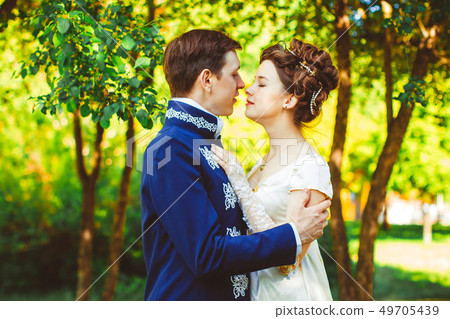 Beautiful couple in evening dress on the nature Beautiful couple in evening dress on the nature 49705439