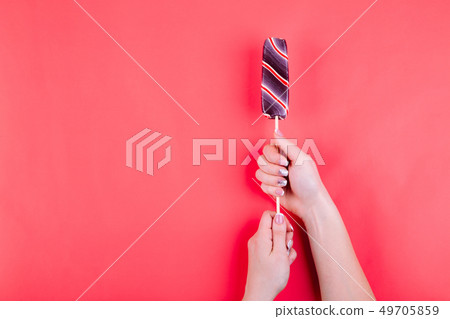 Lollypop on a stick in hand. 49705859