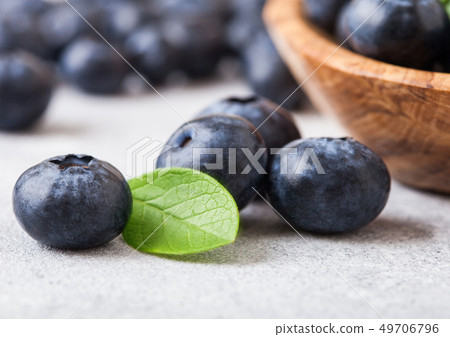 Fresh raw organic blueberries with leaf in wooden 49706796