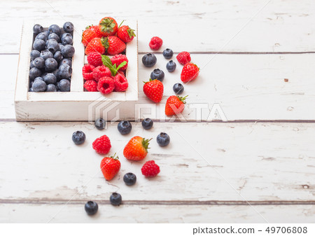 Fresh raw organic berries  in white vintage wooden 49706808