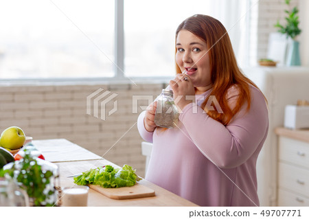 Positive nice woman having a healthy beverage 49707771