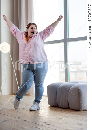 Cheerful nice woman showing her positive emotions Cheerful nice woman showing her positive emotions 49707807
