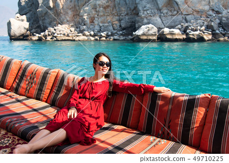 Woman having fun on a dhow boat cruise Woman having fun on a dhow boat cruise 49710225