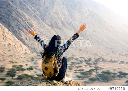 Woman enjoying desert scenery Woman enjoying desert scenery 49710230
