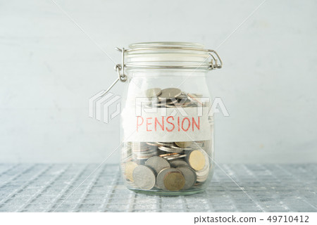 Saving jar with coins Saving jar with coins 49710412