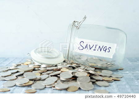 Saving jar with coins 49710440