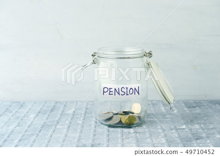 Saving jar with coins Saving jar with coins 49710452