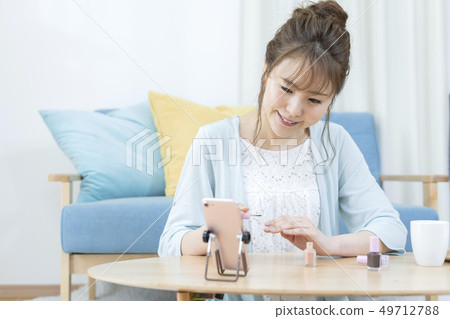 Young Woman Nail Video Call on Smartphone Young Woman Nail Video Call on Smartphone 49712788