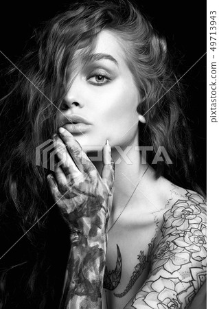 Sexy Girl with Tattoo and color paint on her Body. Sexy Girl with Tattoo and color paint on her Body. 49713943