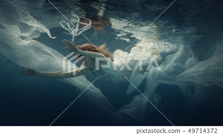 Girl in a white dress under water 49714372