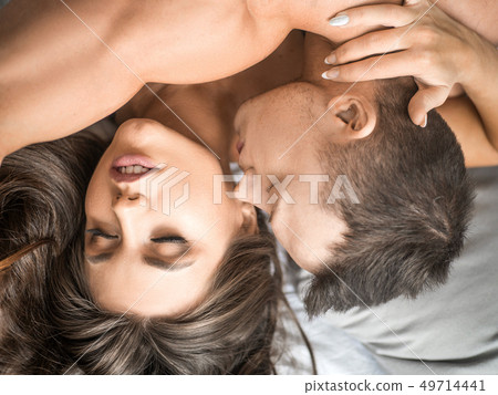 close up of heterosexual couple having sex. Man kissing woman's neck 49714441