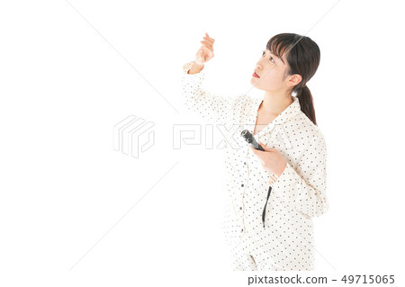 Young woman using a flashlight Young woman using a flashlight 49715065
