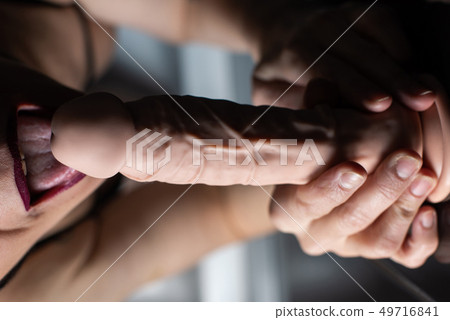 Female mouth and rubber dildo close up 49716841