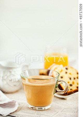 Continental breakfast table with cup of hot Continental breakfast table with cup of hot 49717009