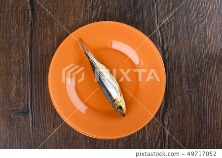 Cold smoked Baltic herring on an orange plate Cold smoked Baltic herring on an orange plate 49717052