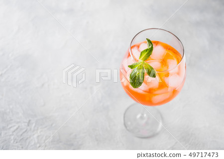 Classic Italian aperol spritz cocktail on light. Classic Italian aperol spritz cocktail on light. 49717473