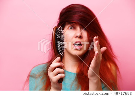 Woman with a comb and problem hair 49717698