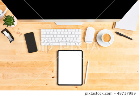 Top view of tablet and large desktop computer 49717989