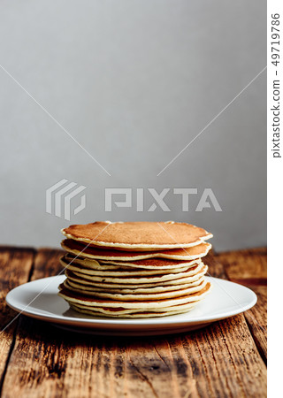 Stack of american pancakes on white plate 49719786