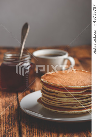 Stack of pancakes on white plate 49719787