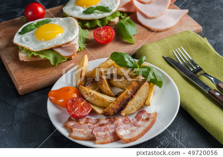 Fried potatoes and bacon on plate 49720056