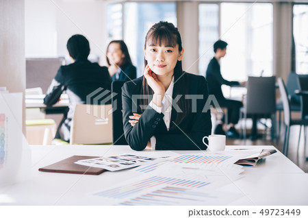 New employee female with elbows at the table 49723449