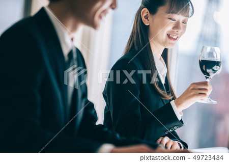 New recruit woman getting a glass of wine at restaurant New recruit woman getting a glass of wine at restaurant 49723484