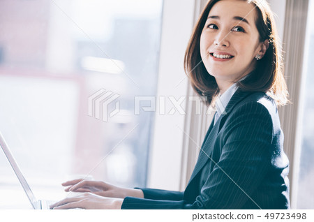 老闆女人在靠窗的座位上前往電腦 49723498