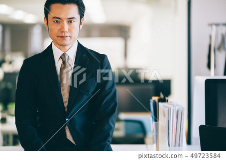 Boss male sitting at desk in office Boss male sitting at desk in office 49723584