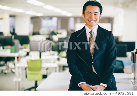 Boss male sitting at desk in office 49723591