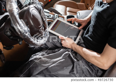 Computer diagnostics of electronic systems of the car. Car mechanic maintains a vehicle with the Computer diagnostics of electronic systems of the car. Car mechanic maintains a vehicle with the 49726730
