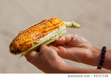 Large cob of corn on the grill. Closeup of the 49727146
