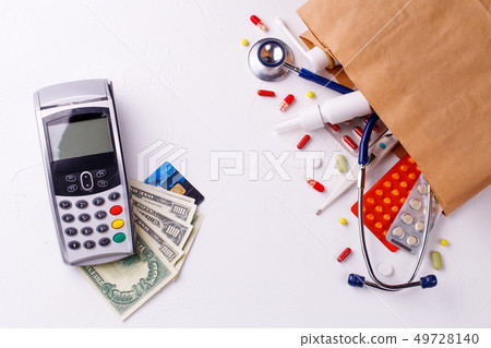 Package with drugs and pin pad, credit card and money. 49728140