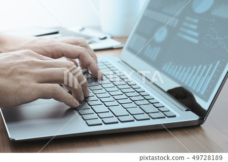 Men making a report on a laptop computer. Blue bar and pie charts. 49728189