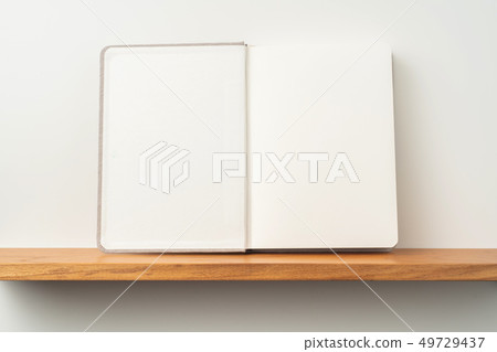 light red fabric notebook stand on bookshelf 49729437