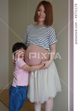 Pregnant woman and boy 49731179