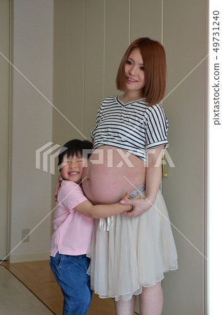 Pregnant woman and boy 49731240