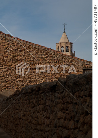 Stone wall and tower of a church. 49731497