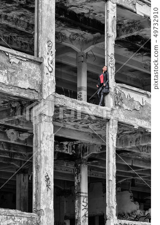 Pretty girl in ruined building 49732910